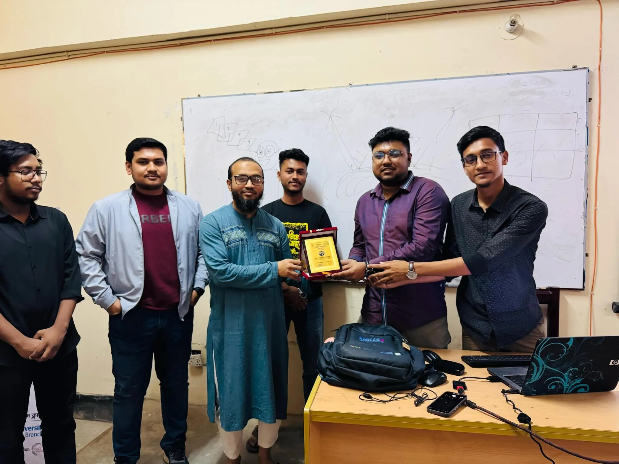 Receiving Crest as a Trainer at IUSC Graphic Design Workshop